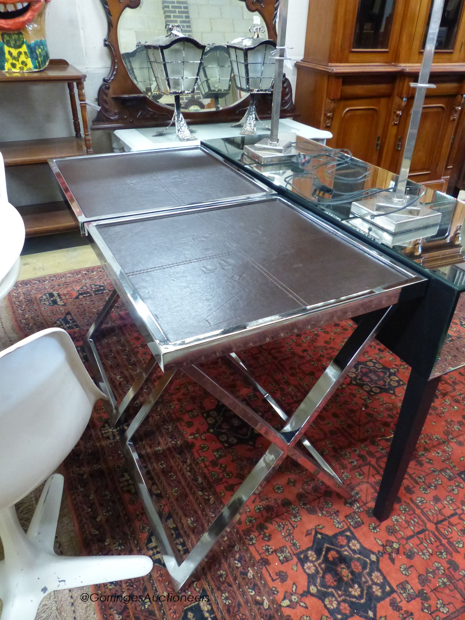 A pair of chrome and leather X-frame lamp tables by Andrew Martin, width 55cm, depth 55cm, height 74cm